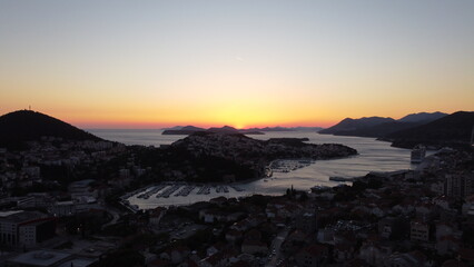 Fototapeta premium Cinematic aerial view of Dubrovnik historic old town and ancient fortified city walls, Croatia