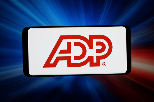 Stuttgart, Germany - 06-11-2026: In this photo illustration, the logo of company Automatic Data Processing Inc. (ADP) is displayed on a smartphone in front of abstract background on computer screen.