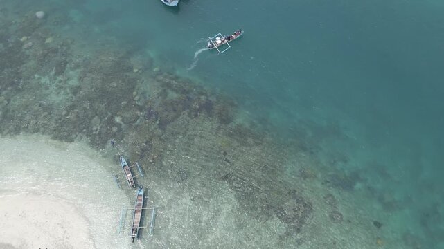 Top Down Aerial Of Outrigger Boat Over Coral Reef And Sand Lampung
