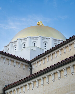 Golden Dome of Mediterranean Style Building Against Blue Sky