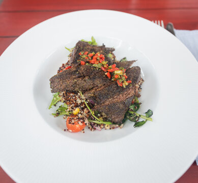 Gourmet Steak Dish with Quinoa Salad on White Plate