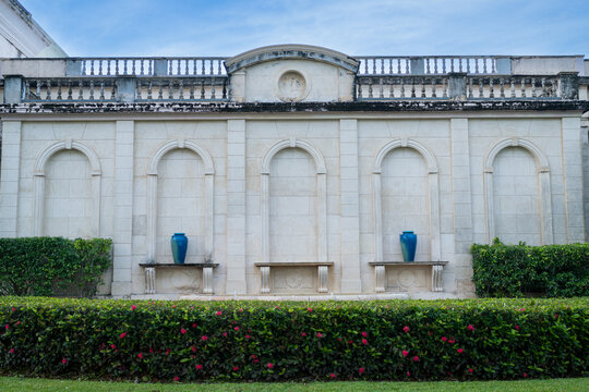 Elegant Stone Wall with Arches and Garden Hedge