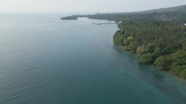 Aerial Over Sebesi Island Coastline Jetty Village And Coral Reef