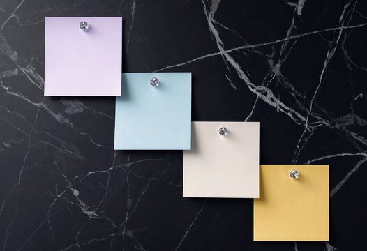 Colorful Sticky Notes Pinned on a Black Marble Background, Top View