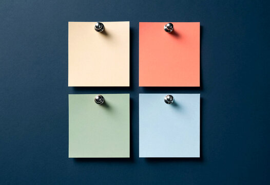 Four Colorful Sticky Notes Pinned to a Dark Blue Wall Overhead View