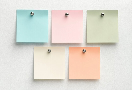 Five Colorful Sticky Notes Pinned to a Textured White Wall