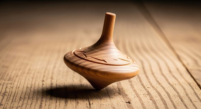 A beautifully crafted handmade wooden spinning top rotates rapidly on a rustic timber surface, creating a soft motion blur of natural grain, indoor, motion, detail