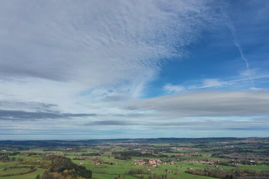Clear blue sky with a few clouds and a rural landscape