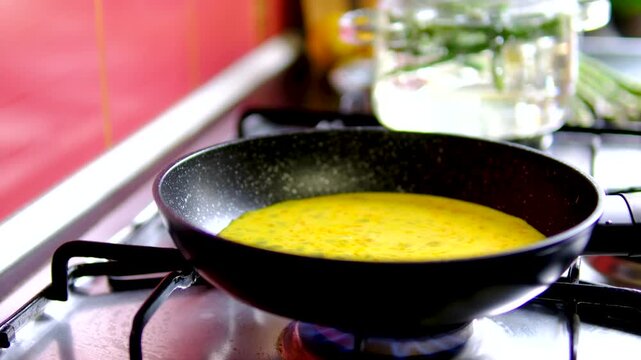 Healthy homemade breakfast with scrambled eggs and asparagus step by step cooking recipe on modern kitchen countertop with fresh summer atmosphere