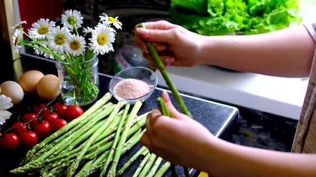 Healthy homemade breakfast with scrambled eggs and asparagus step by step cooking recipe on modern kitchen countertop with fresh summer atmosphere