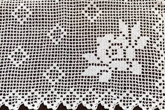 Hand-crocheted lace on the background. Handmade lace used in dowries and decorative embellishments.