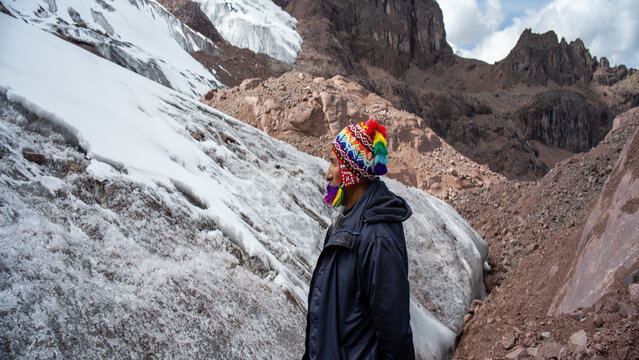 Close up profile of an Andean man contemplating a glacier