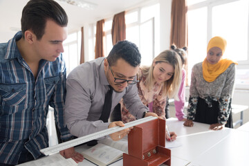 Engineering Students Collaborating on Metal Structural Model in © as-artmedia