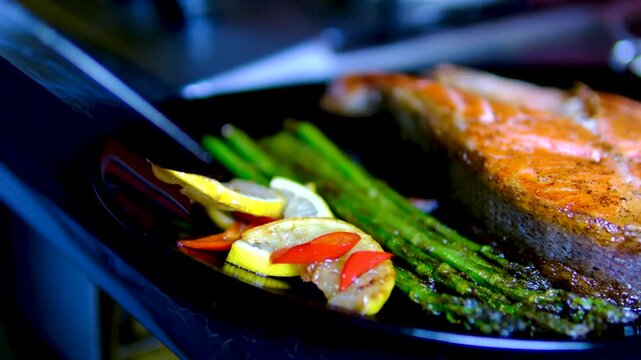 Step by step salmon recipe asparagus garlic butter cooked on stainless steel skillet in modern kitchen healthy gourmet meal preparation salmon recipe, healthy, cooking process, restaurant style meal