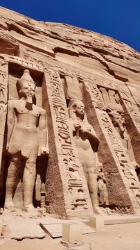 Majestic facade of the Temple of Nefertari of abu simbel in southern egypt. Ancient egyptian monument with colossal statues of ramesses ii and Queen Nefertari