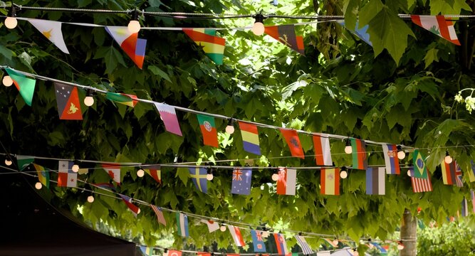 Rows of world flags decorating an outdoor venue during a multicultural event. International celebration, cultural exchange, tourism, and global connection concept.