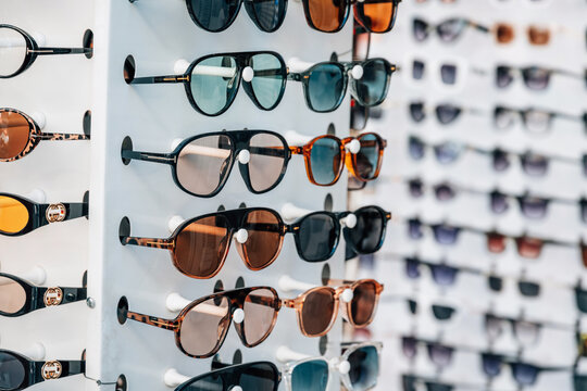 12 May 2026, Bodrum, Turkiye: Row of fashion sunglasses on a display stand in a store, showcasing different styles and colors for summer eyewear