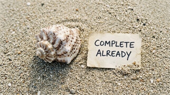Seashell and message on sandy beach