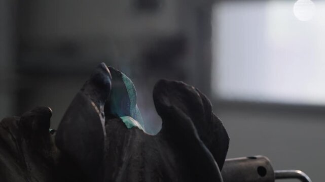 Exploring the process of patination on a surface of metal with green and dark tones in a workshop setting
