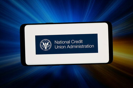 Stuttgart, Germany - 06-11-2026: In this photo illustration, the logo of National Credit Union Administration (NCUA) is displayed on a smartphone in front of abstract background on computer screen.