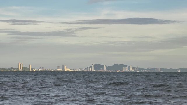 Sriracha coastal city skyline and mountains view from Bangsaen beach, Chonburi, Thailand.