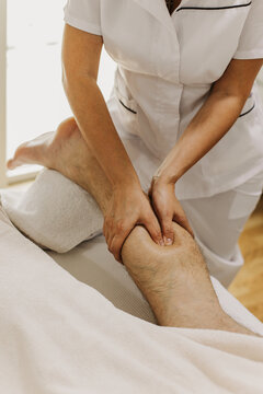 Close up of foot massage therapy session. Female massage therapist's hands.
