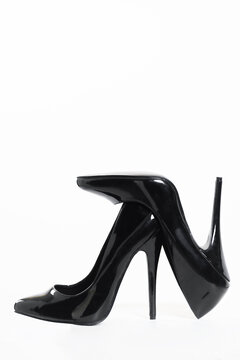 Black patent leather high heel stiletto pumps isolated on white background