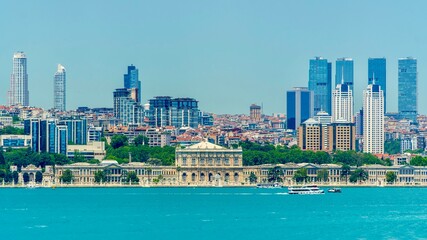 Obraz premium Istanbul, Turkey - June 14, 2026: View of Dolmabahce Palace from the Bosphorus in Istanbul, Turkey, showing the historic waterfront palace, ornate facade, seaside location, and city skyline.