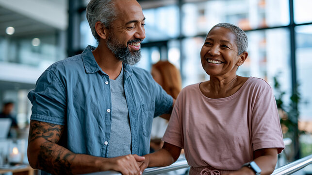 A wide shot of a physical therapist steadying softly a calm patient through bright recovery steps on parallel bars rehab therapy open faces bright clinic daylight workspace