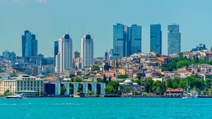 Obraz premium Istanbul, Turkey - June 14, 2026: View of Istanbul from the Bosphorus Strait, showing the city skyline, waterfront buildings, historic landmarks, boats, and scenic urban landscape along the water.