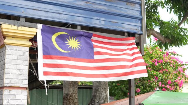 4K slow motion of Malaysian flag Jalur Gemilang waving in the wind