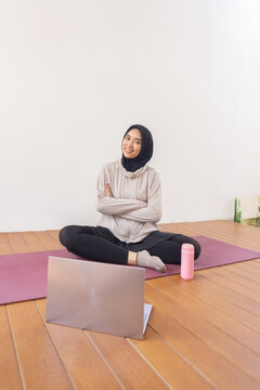 Young jilbab women sitting after exercise with laptop at home