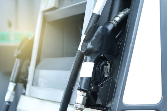 Fuel dispensers businesses at roadside gas stations : Two sets black handle nozzles dispensing diesel fuel are placed left and right dispensing platforms ready service diesel fueled vehicles travel.