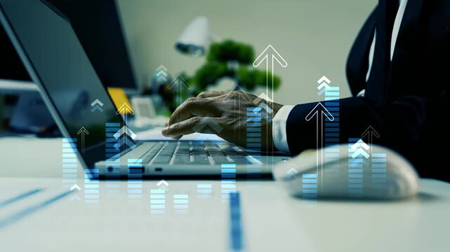 Businessman working on computer with holographic arrow graph bar on the screen, Close-up of a business person typing on a laptop at a desk with hologram digital growth charts and upward arrows 