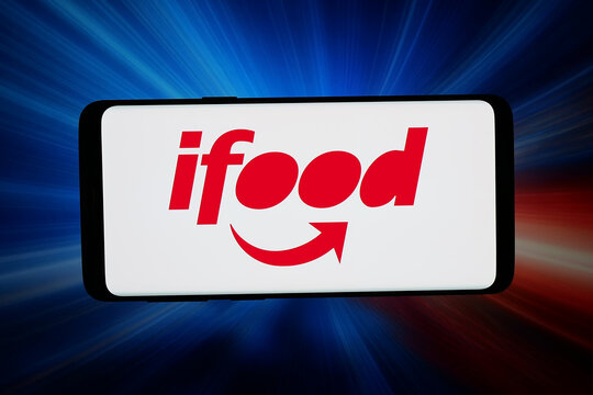 Stuttgart, Germany - 06-11-2026: In this photo illustration, the logo of Brazilian food delivery company iFood is displayed on a smartphone in front of abstract background on computer screen.