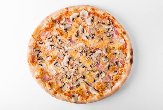 Whole classic Italian pizza Prosciutto e Funghi with ham and fresh sliced mushrooms isolated on white background