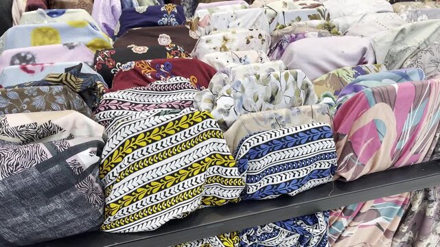 Assorted Traditional Batik and Floral Pattern Fabric Rolls in Market