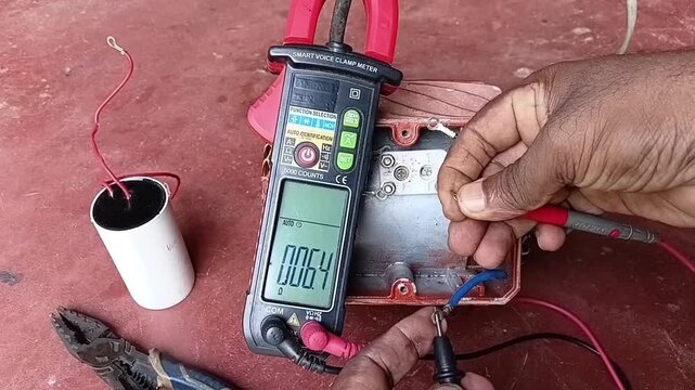 Checking Motor Stator Winding Continuity and Starting Winding Resistance Using Digital Multimeter Close Up
