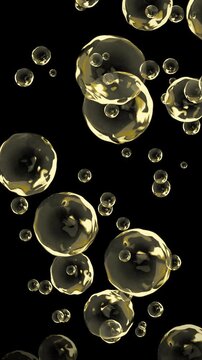 Yellow bubbles of omega 3 oil are flying upward in the air on black background. Health, medical and science concept. It can be used as water, juice, wine drops. Also suitable for cosmetics products.