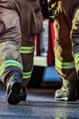 Obraz premium A firefighter is seen walking towards a fire truck in this image vertical frame