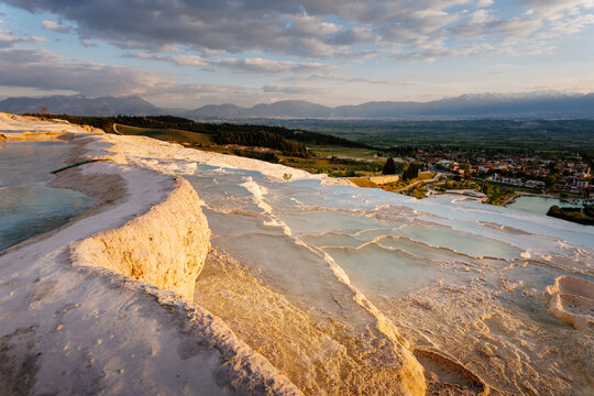 Scenic sunset over the famous white mineral travertine terraces and pools in Pamukkale Turkey