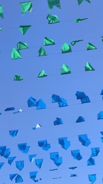 Colorful festival flags against blue sky