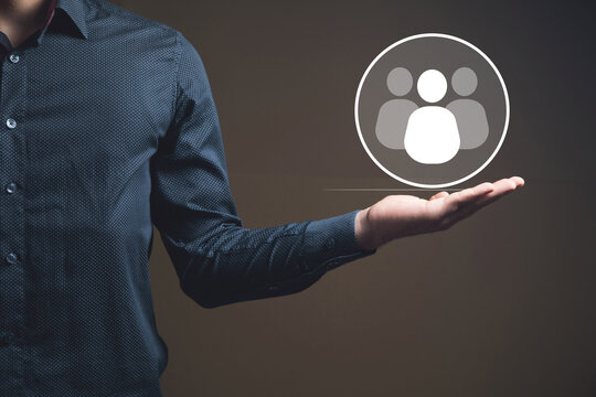 businessman holding a social network icon on a dark background, man and people icon