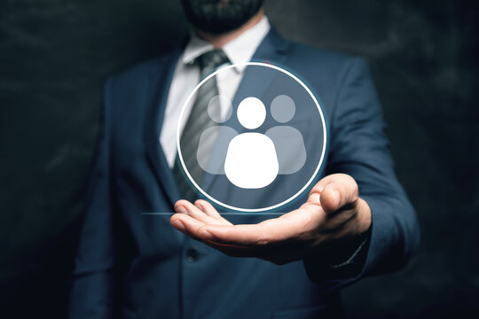 businessman holding a social network icon on a dark background, man and people icon