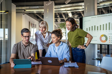 Obraz na płótnie Canvas Diverse business team collaborating on project in modern office