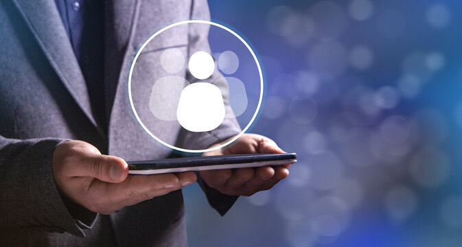 businessman holding a social network icon on a dark background, man and people icon