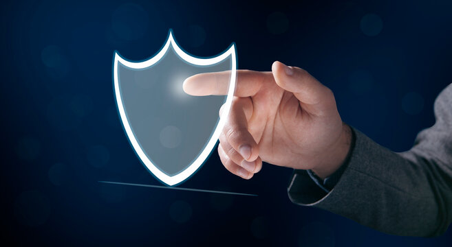 a man taps on a screen with a virtual shield