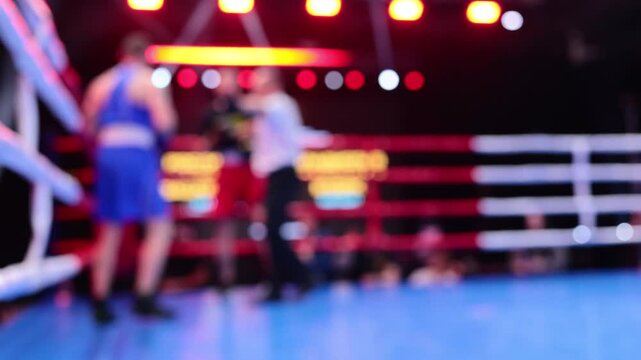 Blurred motion of two boxers exchanging punches in ring during boxing competition