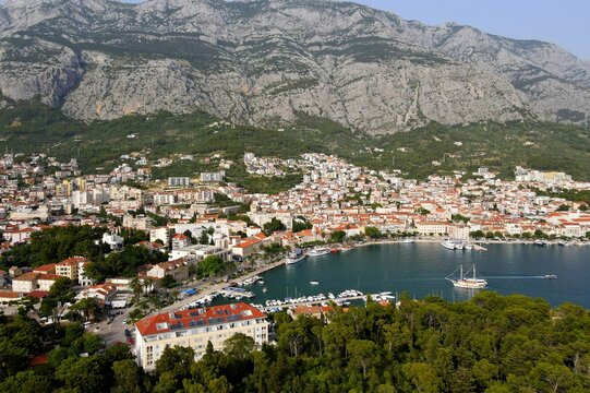 Makarska, Croatia. Coastal town, sea and mountains, Biokovo park. Aerial photography from a drone. Croatian town on the Adriatic Sea. Makarska Riviera