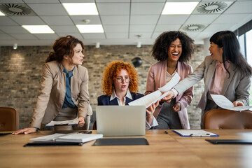 Fototapeta premium Diverse businesswomen collaborating and discussing during office meeting